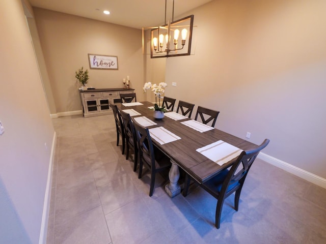 dining area featuring tile patterned flooring and an inviting chandelier