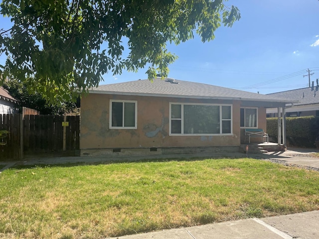 rear view of house featuring a yard