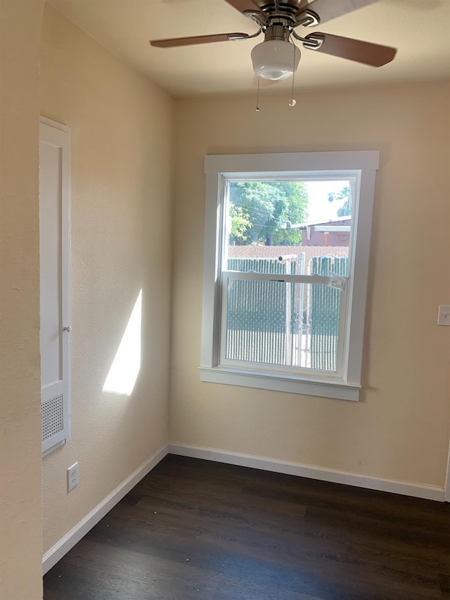 empty room featuring ceiling fan and dark hardwood / wood-style flooring