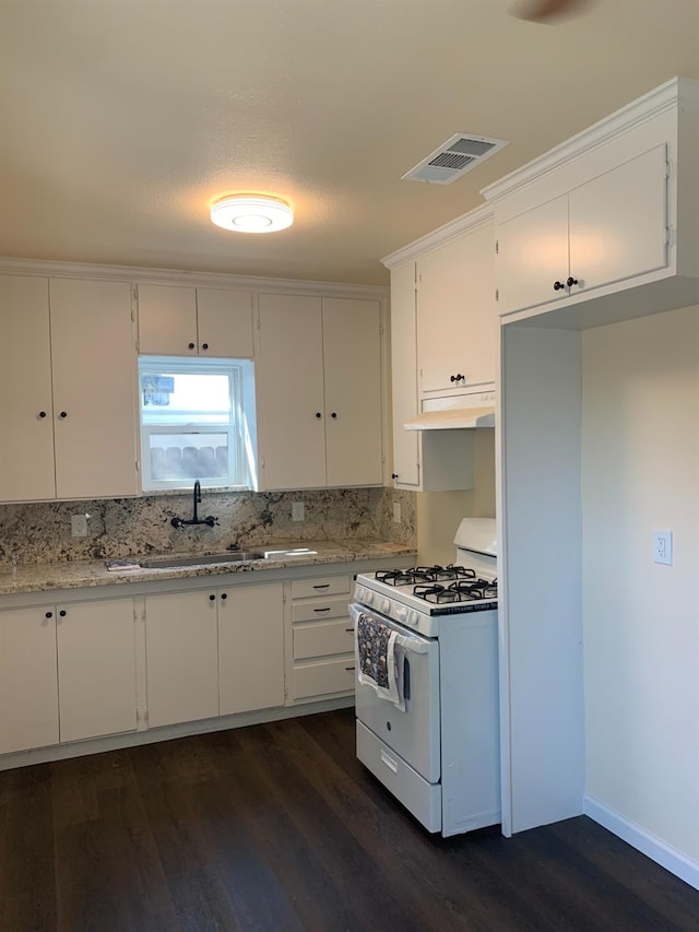 kitchen featuring white cabinets, sink, dark hardwood / wood-style floors, and white gas stove