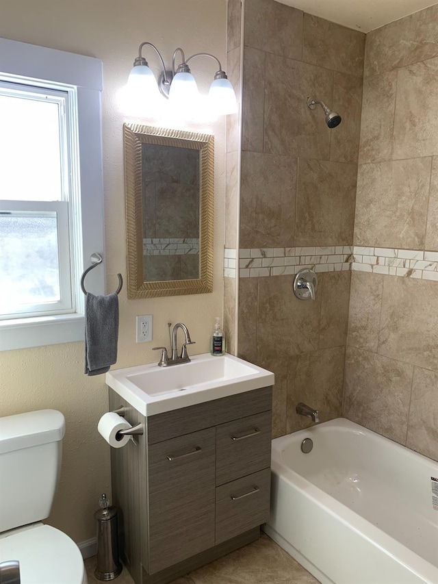 full bathroom featuring tiled shower / bath combo, vanity, and toilet