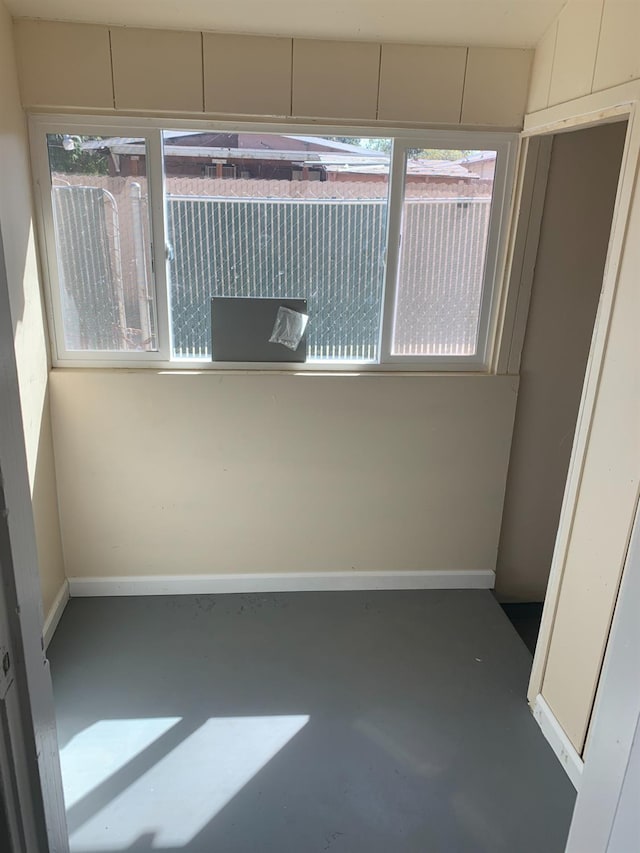 spare room with concrete flooring and plenty of natural light