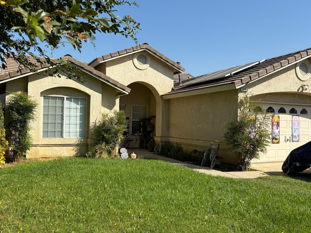 view of front of house with a garage and a front yard