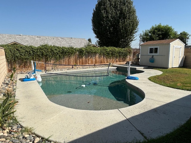 view of pool with a patio and a storage unit