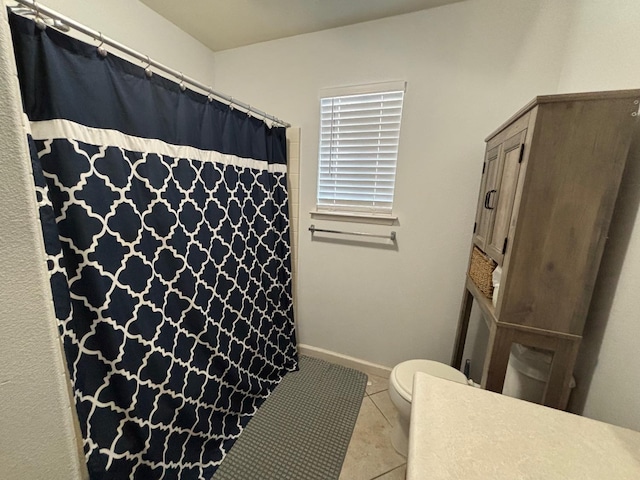 bathroom with tile patterned flooring and toilet