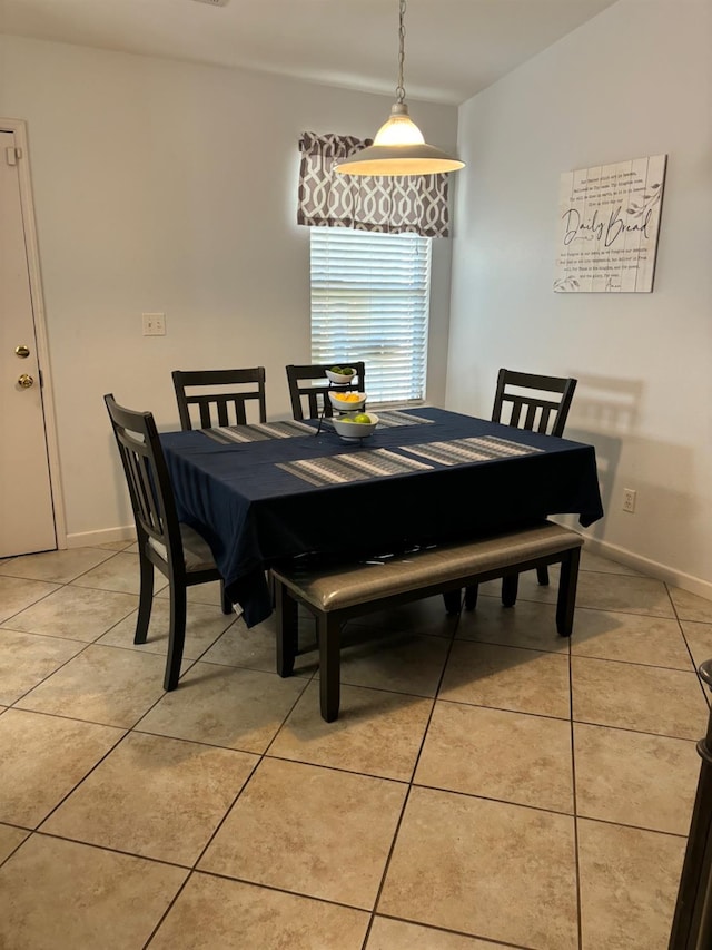 tiled dining room featuring vaulted ceiling