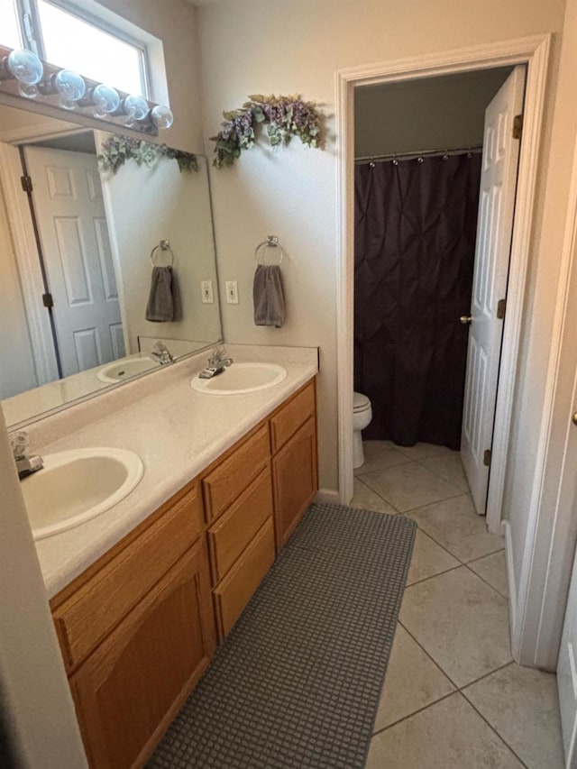 bathroom with vanity, tile patterned flooring, and toilet