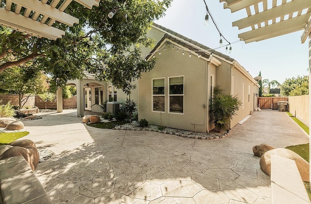 view of front of house featuring a patio, a fenced backyard, and stucco siding