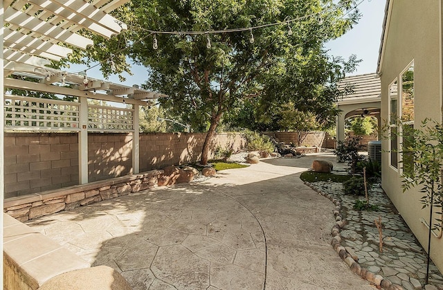 view of patio featuring central AC, a fenced backyard, and a pergola