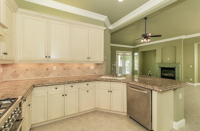 kitchen featuring light tile patterned floors, stone countertops, stainless steel appliances, crown molding, and a sink