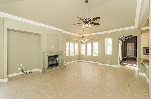 unfurnished living room featuring a glass covered fireplace, crown molding, baseboards, and light tile patterned floors