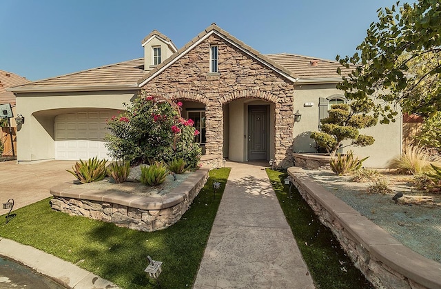 view of front of house with stone siding, a tile roof, and stucco siding