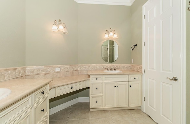 bathroom with ornamental molding, tile patterned flooring, and vanity