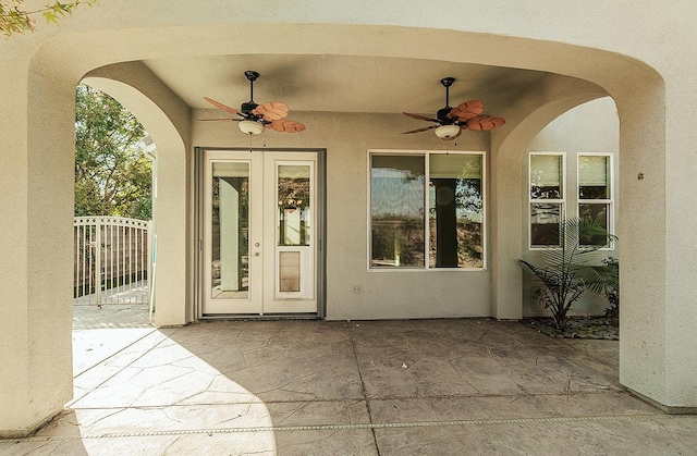 doorway to property featuring stucco siding, ceiling fan, french doors, and a patio