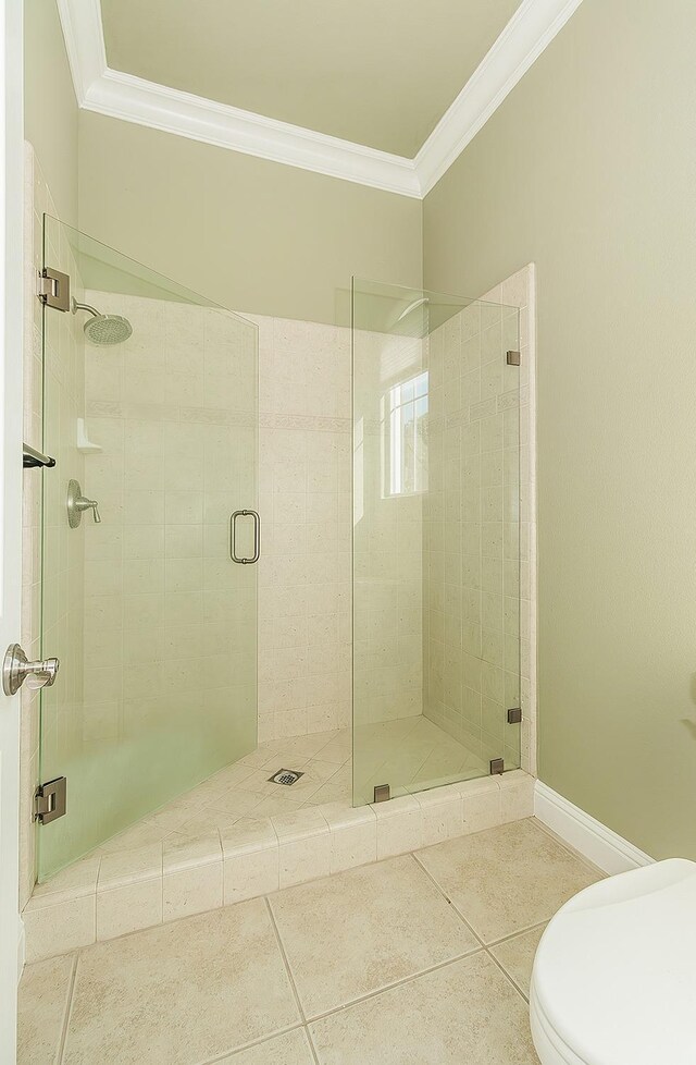 full bath with toilet, tile patterned flooring, a shower stall, and crown molding