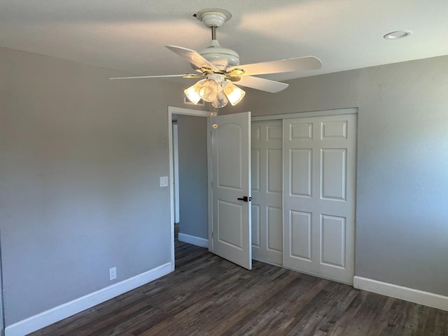 unfurnished bedroom with a closet, ceiling fan, and dark hardwood / wood-style floors