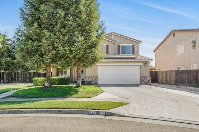 view of front of house featuring a garage and a front yard