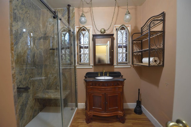 bathroom featuring wood-type flooring, vanity, and a shower with door