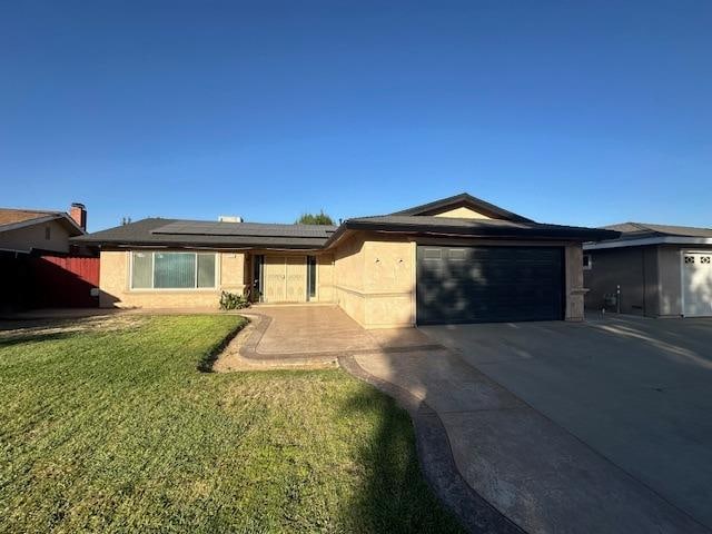 view of front of home with a front lawn and a garage