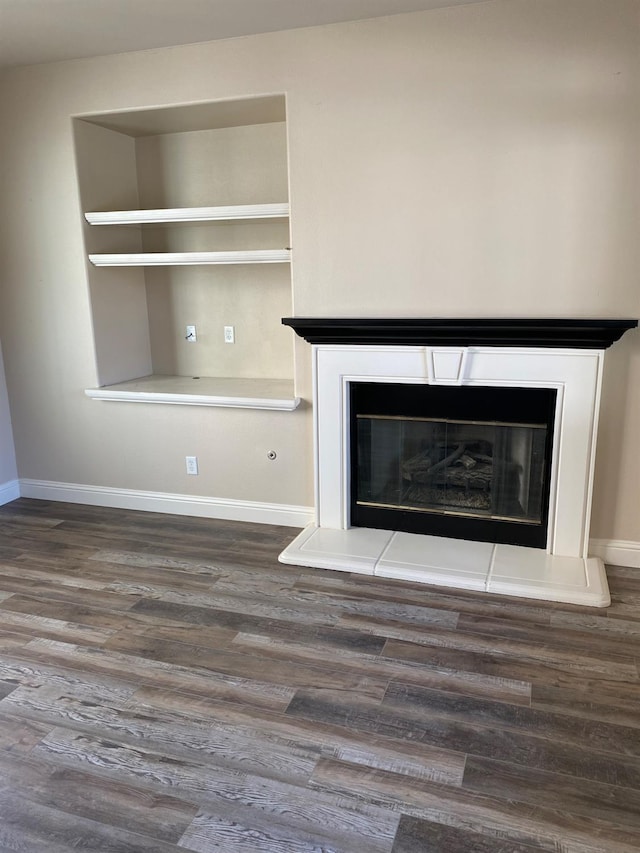 4707 N Arrow Ridge Way N, Clovis, CA 93619 - detailed view of wood finished floors, baseboards, and a glass covered fireplace