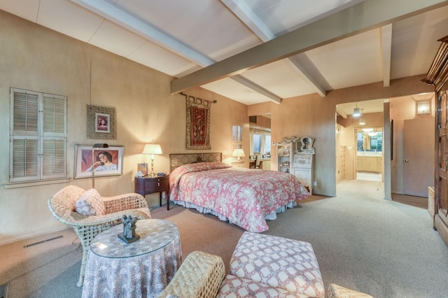 bedroom with carpet, ensuite bathroom, and beam ceiling