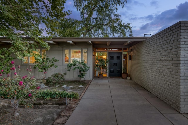 view of exterior entry at dusk