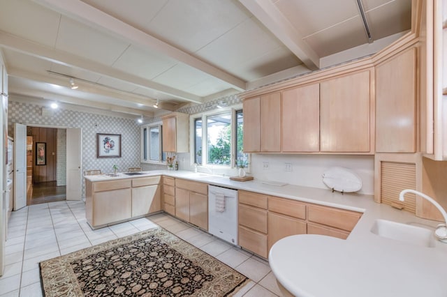 kitchen with white dishwasher, light brown cabinets, kitchen peninsula, and beamed ceiling