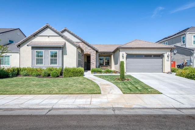 view of front of home with a garage and a front lawn