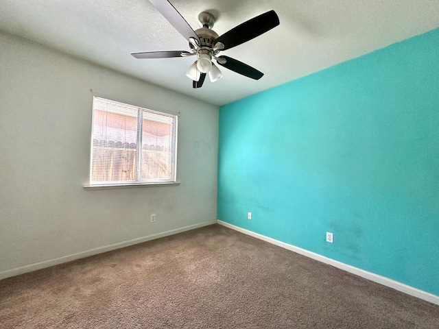 spare room featuring carpet and ceiling fan