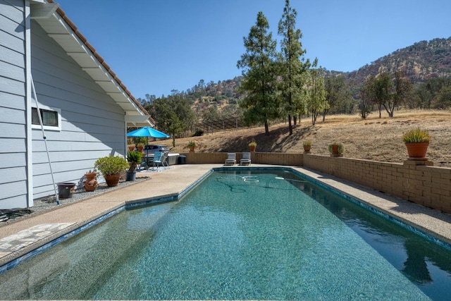 view of pool with a mountain view and a patio area