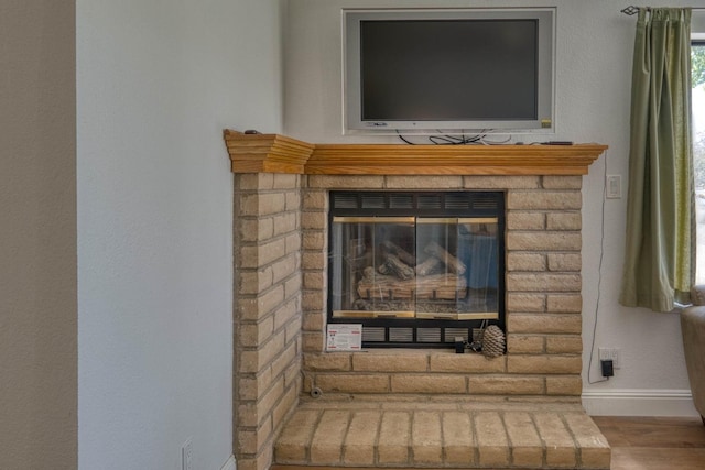 room details with a fireplace and hardwood / wood-style flooring