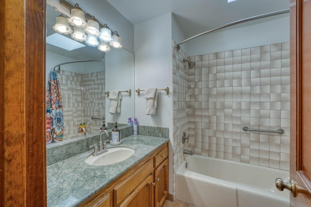 bathroom featuring shower / bath combo, a skylight, and vanity