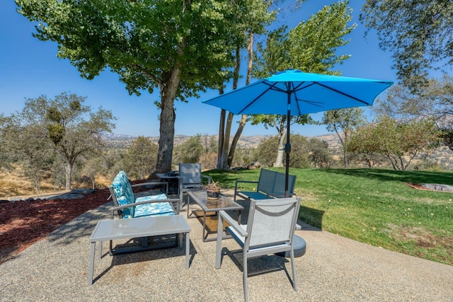 view of patio / terrace with a mountain view and an outdoor fire pit