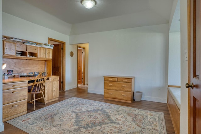 office space featuring built in desk and dark hardwood / wood-style flooring