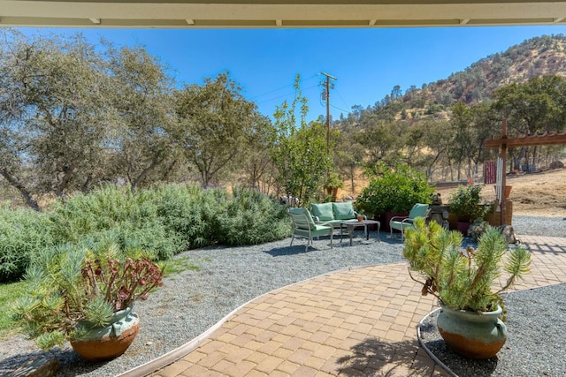 view of patio / terrace featuring a mountain view and an outdoor living space