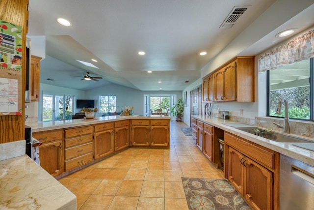 kitchen featuring dishwasher, lofted ceiling, ceiling fan, and a healthy amount of sunlight