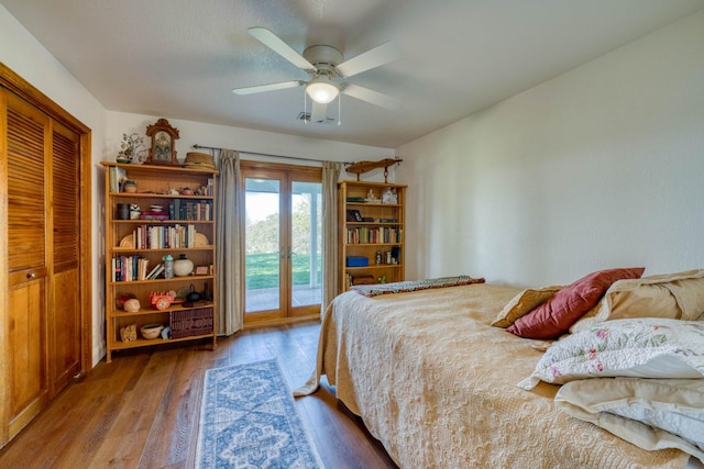 bedroom featuring access to outside, ceiling fan, wood-type flooring, and a closet