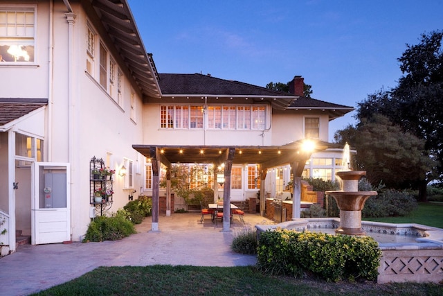 9486 E Lincoln Ave, Del Rey, CA 93616 - back of property with a chimney, a patio area, an outdoor hangout area, and stucco siding