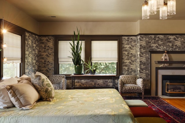 9486 E Lincoln Ave, Del Rey, CA 93616 - bedroom with a fireplace with flush hearth, a chandelier, wood finished floors, and visible vents