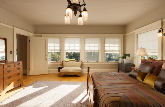 9486 E Lincoln Ave, Del Rey, CA 93616 - bedroom with an inviting chandelier and wood finished floors