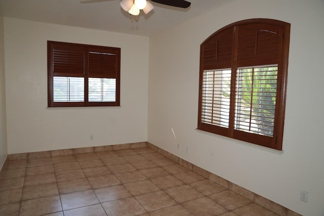 tiled empty room with ceiling fan