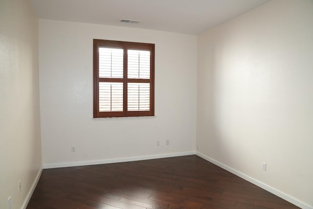 unfurnished room with dark hardwood / wood-style floors