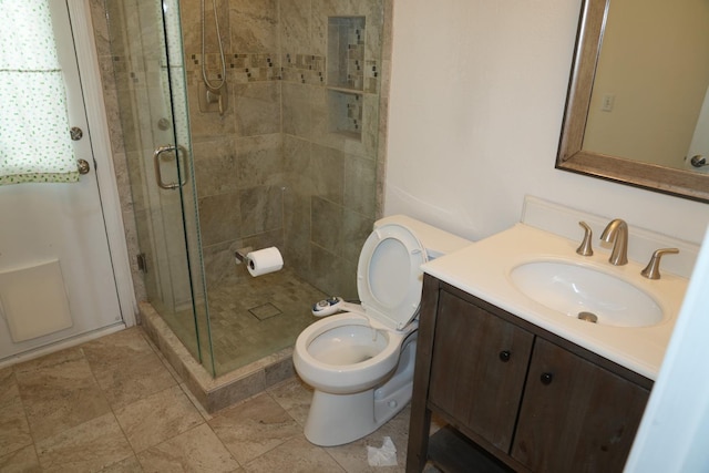 bathroom featuring walk in shower, vanity, and toilet