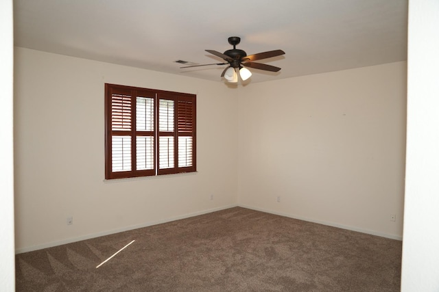 spare room featuring carpet floors and ceiling fan