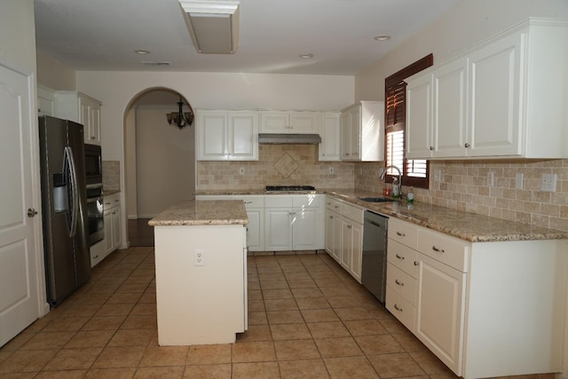 kitchen with light stone counters, a center island, sink, white cabinetry, and stainless steel appliances