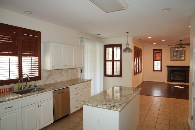 kitchen with white cabinetry, a healthy amount of sunlight, and sink