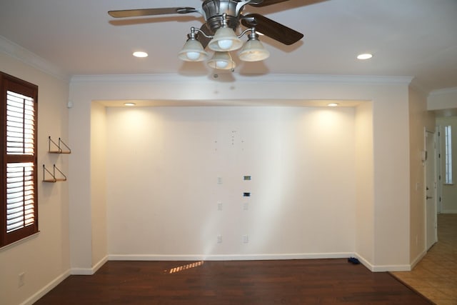 interior space featuring ceiling fan, dark wood-type flooring, and crown molding