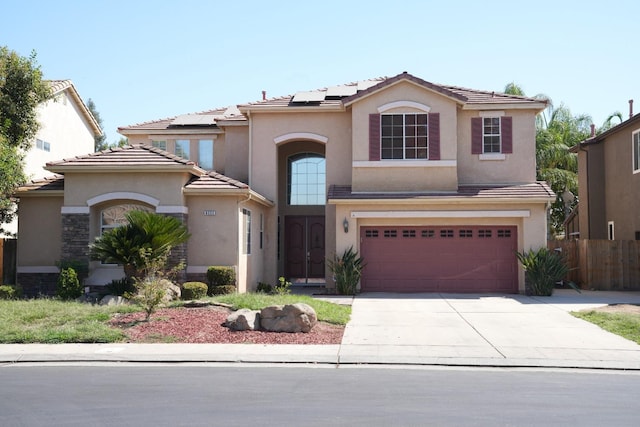 view of front facade featuring solar panels and a garage