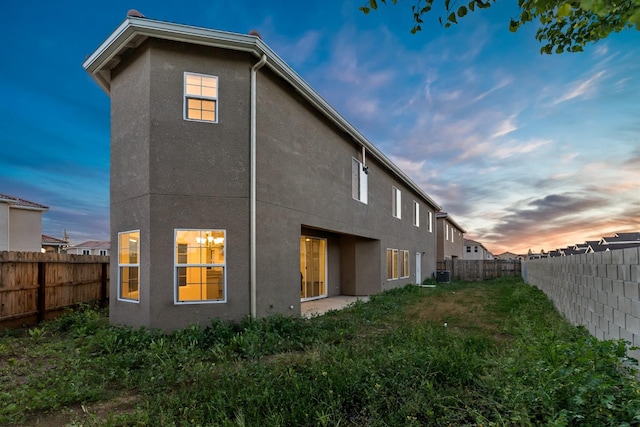 back house at dusk with cooling unit