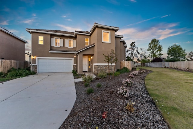 view of front of property with a garage and a yard